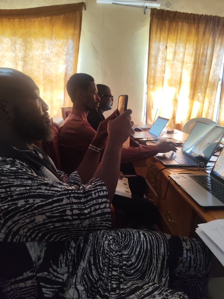 A staff member photographing the projected screen during the workshop