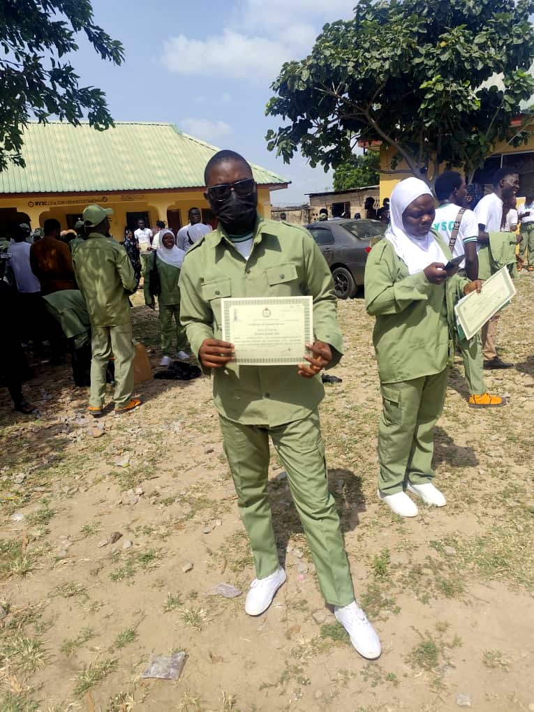 Rasheed Taiwo presenting his NYSC Certificate of National Service